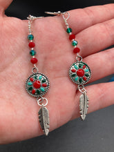 Load image into Gallery viewer, These Southwester Style Silver Feather Light Dainty Beaded Earrings are richly adorned with turquoise, bright red and dark green, and feature silver plated feather charms for a fun, dynamic effect. A perfect match for any Chingona Carbrona, La India Princess, Fierce Goddess Warrior, or Tribal Pattern look.  Measurements: 3” in length
