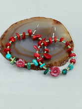 Load image into Gallery viewer, These Bamboo Coral Red Stone Chip earrings are complemented by turquoise and gold glass beading and a shimmery red pressed glass flower charm. The charm&#39;s iridescent shimmer finish has subtle hues of gold, purple, blue and pink.  Measurements: 2&quot; length
