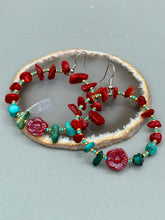 Load image into Gallery viewer, These Bamboo Coral Red Stone Chip earrings are complemented by turquoise and gold glass beading and a shimmery red pressed glass flower charm. The charm&#39;s iridescent shimmer finish has subtle hues of gold, purple, blue and pink.  Measurements: 2&quot; length

