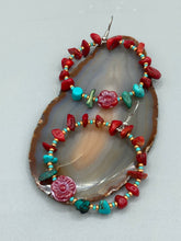 Load image into Gallery viewer, These Bamboo Coral Red Stone Chip earrings are complemented by turquoise and gold glass beading and a shimmery red pressed glass flower charm. The charm&#39;s iridescent shimmer finish has subtle hues of gold, purple, blue and pink.  Measurements: 2&quot; length
