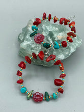 Load image into Gallery viewer, These Bamboo Coral Red Stone Chip earrings are complemented by turquoise and gold glass beading and a shimmery red pressed glass flower charm. The charm&#39;s iridescent shimmer finish has subtle hues of gold, purple, blue and pink.  Measurements: 2&quot; length
