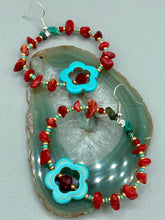 Load image into Gallery viewer, These earrings feature a turquoise magnesite floral bead with a dark red glass bead in the center and artfully beaded with bamboo red coral and turquoise stones. Measurements: 1 3/4" length
