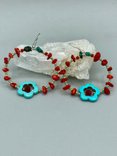 Load image into Gallery viewer, These earrings feature a turquoise magnesite floral bead with a dark red glass bead in the center and artfully beaded with bamboo red coral and turquoise stones. Measurements: 1 3/4" length
