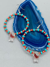 Load image into Gallery viewer, This eye-catching set of earrings features intricately detailed koi fish glass beads, accompanied by smaller teal, red, and gold-hued glass beads. With their bold and vibrant colors, they make a striking statement.  Measurements: 2 1/4” in length   
