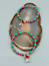 Load image into Gallery viewer, This eye-catching set of earrings features intricately detailed koi fish glass beads, accompanied by smaller teal, red, and gold-hued glass beads. With their bold and vibrant colors, they make a striking statement.  Measurements: 2 1/4” in length   
