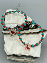 Load image into Gallery viewer, This eye-catching set of earrings features intricately detailed koi fish glass beads, accompanied by smaller teal, red, and gold-hued glass beads. With their bold and vibrant colors, they make a striking statement.  Measurements: 2 1/4” in length   
