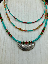 Load image into Gallery viewer, Three strands of Southwestern Style Inspired Adjustable Choker Beaded Necklace features an eye-catching blend of vibrant turquoise, red, green, gold, and yellow glass beads, accented with a wide silver plated tribal pattern pendant.  Measurements:  Necklace is 15 1/2” adjustable up to 18" in length
