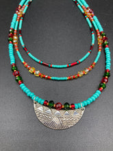 Load image into Gallery viewer, Three strands of Southwestern Style Inspired Adjustable Choker Beaded Necklace features an eye-catching blend of vibrant turquoise, red, green, gold, and yellow glass beads, accented with a wide silver plated tribal pattern pendant.  Measurements:  Necklace is 15 1/2” adjustable up to 18" in length
