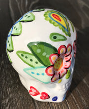 Load image into Gallery viewer, Bring Southwest beauty to any space with this unique ceramic sugar skull art. Hand-painted with bright colors, this piece captures the spirit of Sedona in a Dia de Los Muertos ofrenda. Let this delightful piece evoke the magical beauty of the amazing landscape you&#39;ll never forget. H 2 3/4” x W 2” x D 2”
