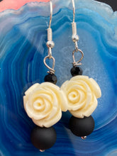 Load image into Gallery viewer, White rose detailed reconstituted quartize beads with black round beads fish hook style earrings are 1” 
