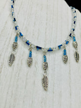 Load image into Gallery viewer, Silver And Blue Wise Owl Charm Choker Style Glass Beaded Necklace. Whimsical and elegant necklace has two different styles of tiny cute owls with silver plated feathers. Some say wearing an owl pendant around your neck is just want you need for a better connection to your intuition. Owls symbolize wisdom, the wisdom that comes to prevent hasting rushing or being impulsive. Necklace comes with matching earrings, necklace is 16” adjustable up to 18&quot; in length - hanging owls and feather pendant are 2” Height

