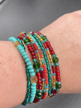 Load image into Gallery viewer, Vibrant And Enchanting Southwest Style Jewelry. This stunningly bold statement piece contains nine beaded strands full of variant turquoise, bright and dark reds and greens, golds and yellows. I created this beautiful jewelry piece by using a wide variety of different bead shapes from large and small round, round tubes, and squares.  Measurements: 7 1/2" in length
