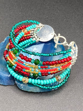 Load image into Gallery viewer, Vibrant And Enchanting Southwest Style Jewelry. This stunningly bold statement piece contains nine beaded strands full of variant turquoise, bright and dark reds and greens, golds and yellows. I created this beautiful jewelry piece by using a wide variety of different bead shapes from large and small round, round tubes, and squares.  Measurements: 7 1/2" in length
