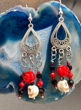 Load image into Gallery viewer, Frida Kahlo Inspired Earrings, Tiny Howlite Skull Beads With Red Quartize Rose Beads. Elegant set of earrings captures Frida Kahlo&#39;s signature floral crown on her head. Red and black shimmery glass beads to give a little pop of color and incorporated some movement. These are a beautiful piece of jewelry to wear for inspiration or a great Dia De Los Muertos jewelry piece. You can dress these up or down, it will definitely give your outfit a unique look. 2 ” in length
