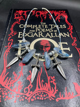Load image into Gallery viewer, This elegant and dark necklace features shimmering light silver and gray glass beads of varying sizes and shapes for texture and dimension. The necklace is finished with blue luster crystal stone nuggets and nickel-free dagger pendants, creating a beautiful draping effect. Measurements:   Necklace is 17”adjustable up to 19&quot; 
