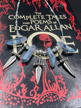 Load image into Gallery viewer, This elegant and dark necklace features shimmering light silver and gray glass beads of varying sizes and shapes for texture and dimension. The necklace is finished with blue luster crystal stone nuggets and nickel-free dagger pendants, creating a beautiful draping effect. Measurements:   Necklace is 17”adjustable up to 19&quot; 
