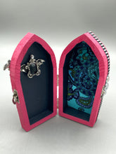 Load image into Gallery viewer, This unique handmade Pink Spooky Glam Wood Coffin Ring Box offers a statement piece for your witchy home decor. Its macabre collections boast a black and pink wood coffin with large shimmery bat embellishments and decorative black crystals around the exterior. Open up the box to find a bright turquoise mandala fabric and a tiny black crystal bat decoration for a truly eerie feel.
