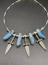 Load image into Gallery viewer, This elegant and dark necklace features shimmering light silver and gray glass beads of varying sizes and shapes for texture and dimension. The necklace is finished with blue luster crystal stone nuggets and nickel-free dagger pendants, creating a beautiful draping effect. Measurements:   Necklace is 17”adjustable up to 19&quot; 
